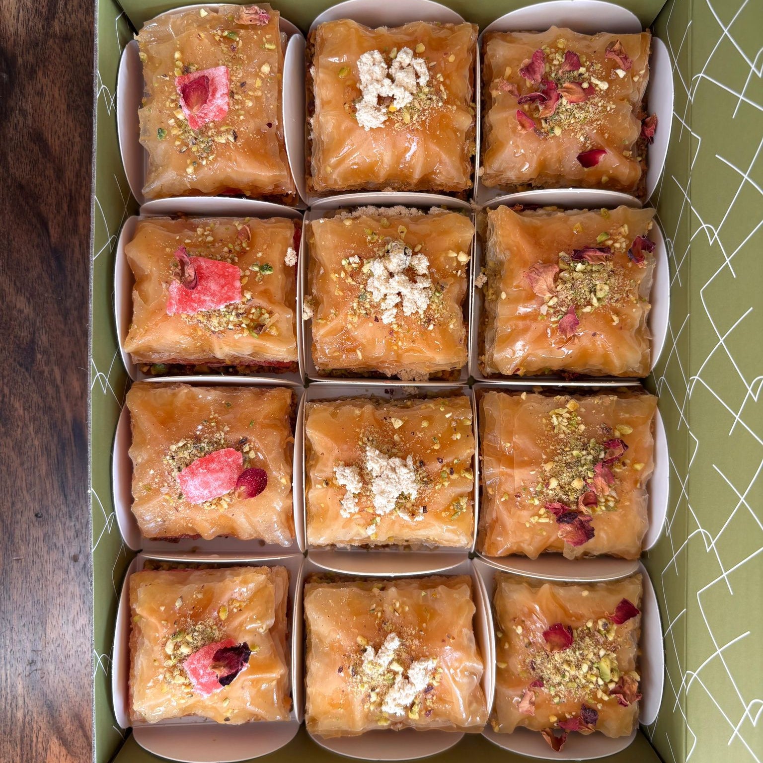 Box of square baklawa in various flavours in an open baklabox 