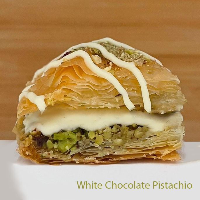 White chocolate pistachio baklawa  with a wooden background